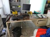 a desk with a laptop and a monitor on it