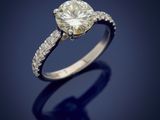 a close up of a diamond ring on a blue background