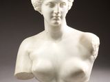 marble bust of a woman on a pedestal on a gray background