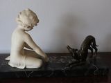 a statue of a child and a dog on a table