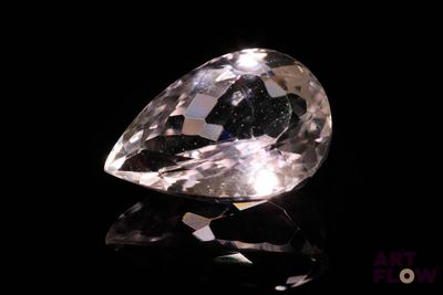 a close up of a diamond on a black surface