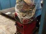 a stack of luggage sitting on top of a cart in a warehouse