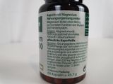 a close up of a bottle of pills on a table