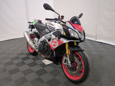 a motorcycle that is parked on a black and white checkered floor