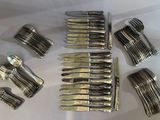 a lot of forks and knives on a table