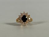 a close up of a black and white diamond ring on a table
