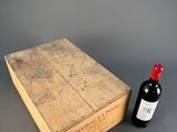a wooden box with a bottle of wine next to it