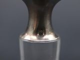 a close up of a silver vase with a black background
