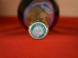 a bottle of beer sitting on a red cloth