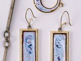 a pair of earrings and a pair of scissors on a table