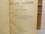 an old book opened to show the title of a novel