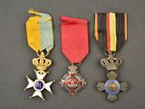 three medals and a star on a black background