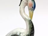 a figurine of a bird that is standing on a table