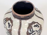 a white vase with a brown and black design on it