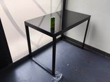 a glass table with a bottle of beer on top of it