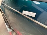 a sticker on the door of a car that is parked on the side of the road