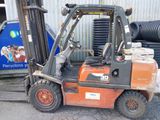 a forklift that is parked in front of a building