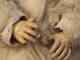 a close up of a doll wearing a white dress