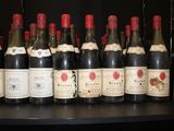 bottles of wine are lined up on a shelf in a wine cellar