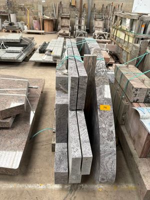 a large pile of granite blocks in a warehouse