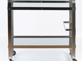 an image of a metal and glass bar cart on wheels
