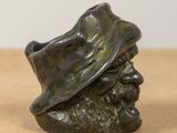 a statue of a man with a hat on a table