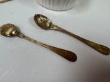 two spoons that are sitting next to a cup