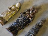 three figurines sitting on the floor next to each other