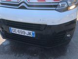 a white van with red stripes parked in a parking lot