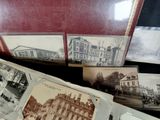 many old photos of a building on display in a case