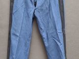 un pantalon bleu et noir suspendu à un cintre accroché au mur