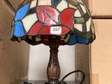 a lamp that is sitting on a table next to a box