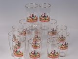 six shot glasses and a jug with a crown on the top