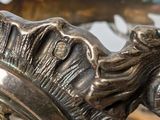 a close up of a silver plate with a horse on it