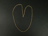 un collier avec une chaîne en or sur fond noir