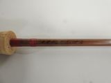 an old baseball bat with writing on it hanging on a wall