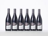 six bottles of wine lined up in a row on a table