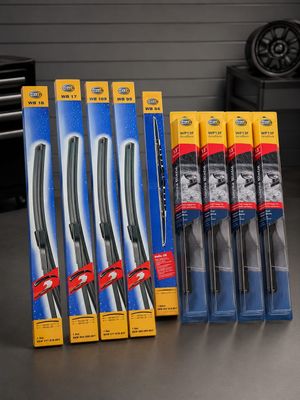 six wipe blades are sitting on a table in front of a shelf