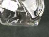 a glass jar with a spoon and fork inside of it