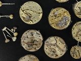 many different types of watches on a black surface
