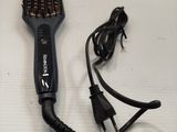a hair dryer and a hair brush on a table