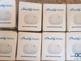 six boxes of small white balls sitting on top of a wooden table