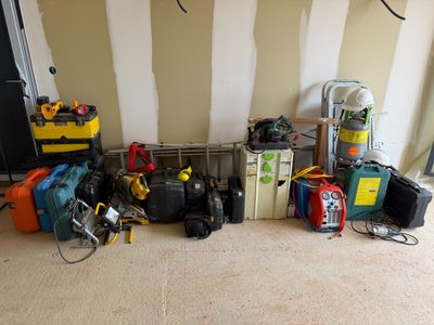 many different types of luggage and tools on the floor