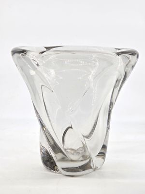 a glass vase that is sitting on a white surface