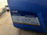 a close up of a blue cooler sitting on top of a wooden floor