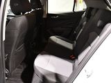 the back seats of a car with a laptop in the passenger seat
