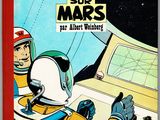 la couverture d'une bande dessinée représentant un homme en combinaison spatiale assis à un bureau