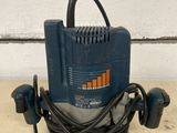 an image of a blue and black electric sander sitting on top of a table