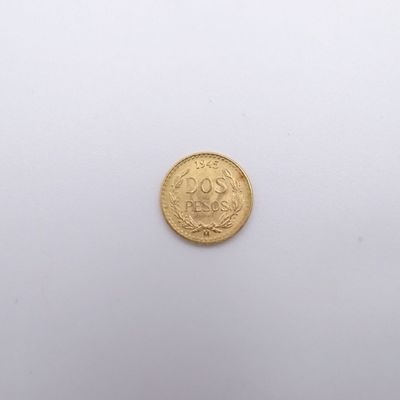 a close up of a gold coin on a white surface