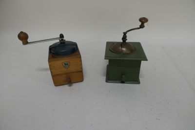 two different types of coffee grinders on a white surface